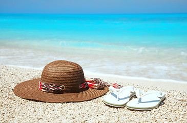 Image showing Hat and flip-flops on a beach