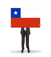 Image showing Businessman holding a big card, flag of Chile