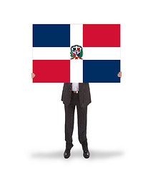 Image showing Businessman holding a big card, flag of the dominican republic