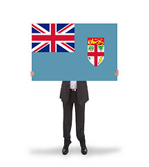 Image showing Businessman holding a big card, flag of Fiji