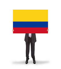 Image showing Businessman holding a big card, flag of Colombia