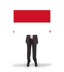 Image showing Businessman holding a big card, flag of Indonesia