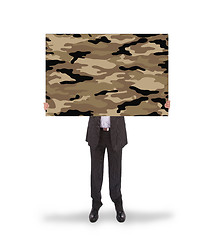 Image showing Businessman holding a big card, camouflage 