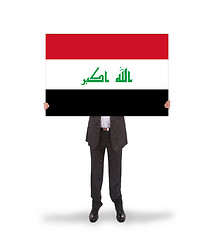 Image showing Businessman holding a big card, flag of Iraq