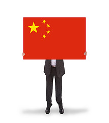 Image showing Businessman holding a big card, flag of China