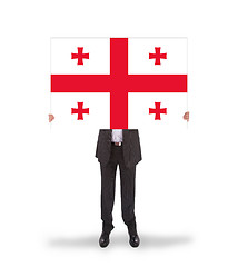 Image showing Businessman holding a big card, flag of Georgia