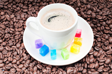 Image showing Multicolored slabs of shugar and cup of coffee