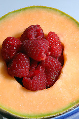 Image showing cantaloupe with raspberries