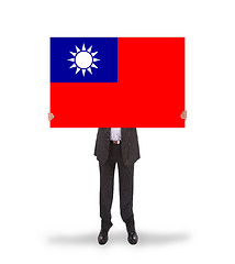 Image showing Businessman holding a big card, flag of Taiwan
