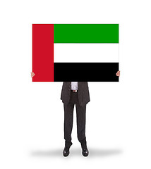 Image showing Businessman holding a big card, flag of the UAE