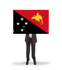 Image showing Businessman holding a big card, flag of Papua New Guinea