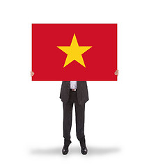Image showing Businessman holding a big card, flag of Vietnam