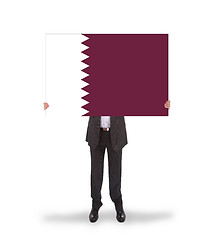 Image showing Businessman holding a big card, flag of Qatar