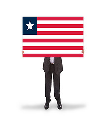 Image showing Businessman holding a big card, flag of Liberia