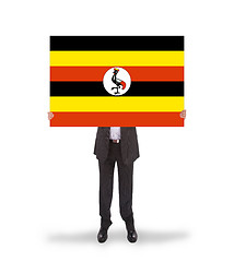 Image showing Businessman holding a big card, flag of Uganda