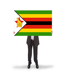 Image showing Businessman holding a big card, flag of Zimbabwe