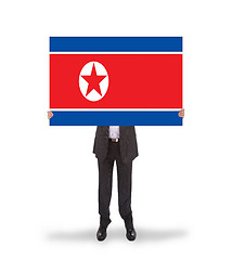 Image showing Businessman holding a big card, flag of North Korea