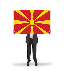 Image showing Businessman holding a big card, flag of Macedonia