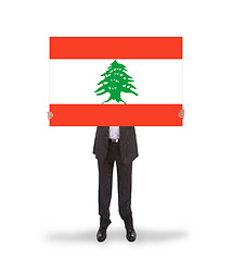 Image showing Businessman holding a big card, flag of Lebanon