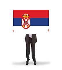 Image showing Businessman holding a big card, flag of Serbia