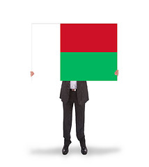 Image showing Businessman holding a big card, flag of Madagascar