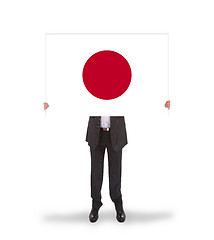 Image showing Businessman holding a big card, flag of Japan