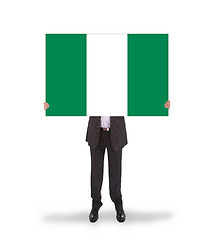 Image showing Businessman holding a big card, flag of Nigeria