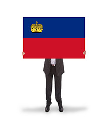 Image showing Businessman holding a big card, flag of Liechtenstein