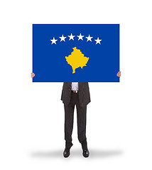 Image showing Businessman holding a big card, flag of Kosovo