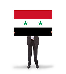 Image showing Businessman holding a big card, flag of Syria