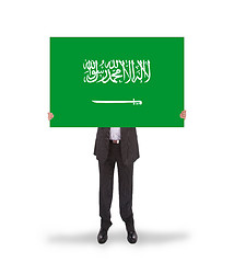 Image showing Businessman holding a big card, flag of Saudi Arabia