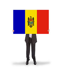 Image showing Businessman holding a big card, flag of Moldova