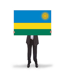 Image showing Businessman holding a big card, flag of Rwanda