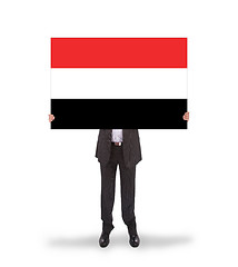 Image showing Businessman holding a big card, flag of Yemen