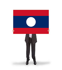 Image showing Businessman holding a big card, flag of Laos