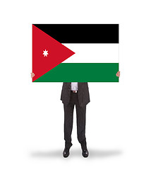 Image showing Businessman holding a big card, flag of Jordan