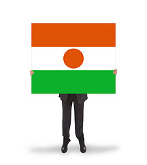 Image showing Businessman holding a big card, flag of Niger