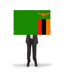 Image showing Businessman holding a big card, flag of Zambia