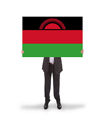 Image showing Businessman holding a big card, flag of Malawi