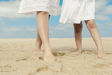 Image showing Woman and her daughter on the beach