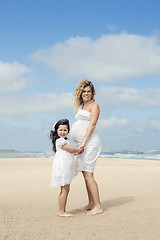 Image showing Pregnant woman and her daughter on the beach