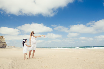 Image showing Pregnant woman and her daughter on the beach