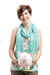 Image showing Happy woman with a piggy bank