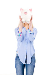 Image showing Beautiful woman holding  a piggy bank