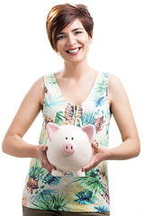 Image showing Happy woman with a piggy bank