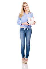 Image showing Beautiful woman holding  a piggy bank