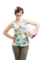 Image showing Beautiful woman holding a piggybank