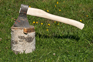 Image showing An axe and a stump.