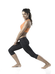 Image showing fit woman stretching on white