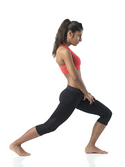 Image showing fit woman stretching on white